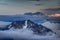 Peaks of Karavanke range and Kamnik-Savinja Alps rise above clouds