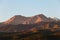 The peaks and spacious slopes of the Trans-Ili Alatau mountains are illuminated by the morning sun.