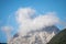 peaks of the wetterstein mountains in the clouds in the early morning, view from mittenwald town