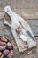 Pealed and halved Jerusalem artichokes on wooden cutting board to preparing food