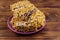 Peanut brittles in plate on wooden table