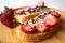 Peanut butter spread toasts with chocolate chips, strawberries, coconut flakes and homemade bread