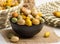 peanut coated served in a bowl isolated on napkin side view of nuts on grey background