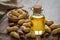 Peanut oil in glass bottle and peanuts on wooden table