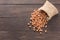 Peanut in sacks on the wooden background