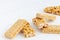 Peanut and sesame brittle on white wooden background