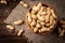 Peanut in the shell in wooden bowl on dark wooden background