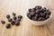 Peanuts in cacao powder in bowl and scattered dragee