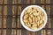 Peanuts drying on white dish