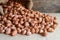 Peanuts in hemp sack on wooden background