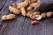 Peanuts in a miniature burlap bag on wooden