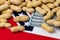 Peanuts in shell on flag of Mississippi with 100 dollar bills.