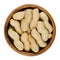 Peanuts with shell in wooden bowl over white