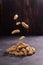 Peanuts soaring in the air on rustic textured background. Healthy food and diet.