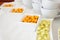 Peanuts with yellow and orange batter in white containers on the