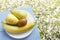 Pear, banana and kiwi fruit on wooden blue table and on natural flowers background. Fresh organic fruits. Top view. Copy space