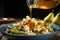 Pear and blue cheese salad in ceramic plate on wooden table, close-up. Honey being poured into pear salad made from microgreens,