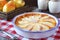 Pear clafoutis and and yellow pears in wicker basket