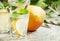 Pear cocktail with soda, fruit slices and mint on an old wooden