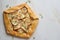 Pear galett with blue cheese, savory pie, marble table, copy space, top view