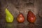 Pear green and red on a wooden table.