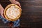 Pear pie with cream in female hands, homemade pastries on wooden table, with spices. Copy space