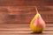 Pear ripe on wooden table from board.