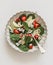 Pear, spinach, gorgonzola cheese, strawberry salad on a light background, top view