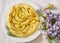 Pear tart with thyme on purple table summerly flowers