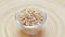 Pearl barley heap in a glass bowl rotating