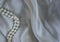 Pearl Beads on a Light Background Fabric. Abstract Background Luxurious Fabric, Wavy Pleats Grunge Silk Texture Satin Velvet