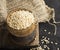 Pearl dry cereal in a vintage wooden bowl on a plain dark background for text placement and advertising. Selective focus