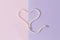Pearl heart on a pink-gray background. Flat lay, top view,