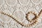 Pearl necklace on lace fabric