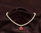 Pearl necklace with red ruby stone in black background