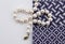Pearl necklace on white background and blue and white indigo cloth
