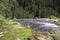 Pearl shoals with wading hiker collecting litter