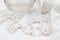 Pearls, lace dress and perfume bottle defocused photo - Wedding