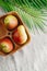 Pears on a linen napkin decorated with palm leaf