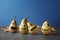 Pears painted for Halloween on table against color background