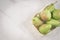 Pears in a straw box on a white marble background/pears in a straw box on a white marble background, top view and copy space