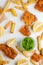 Peas, lemon, fish and chips on white background