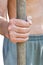 Peasant holds old wooden tool handle