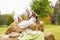 Peasant mother with little baby in summer playing on haystack in the field