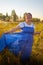 Peasant plump chubby pleasant woman in green grass field. Girl in blue old russian dress posing outdoors in nature in a