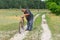 Peasant standing on a country road and inspecting old rusty bicycle