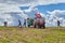 Peasants remove old grass from field with uses manure fork.