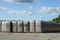 Peat extraction, many large bags of peat on the production area of a factory under a blue sky