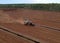 Peat Harvester Tractor on Collecting Extracting Peat. Mining and harvesting peatland. Area drained of the mire are used for peat