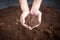 Peat moss soil on hand woman